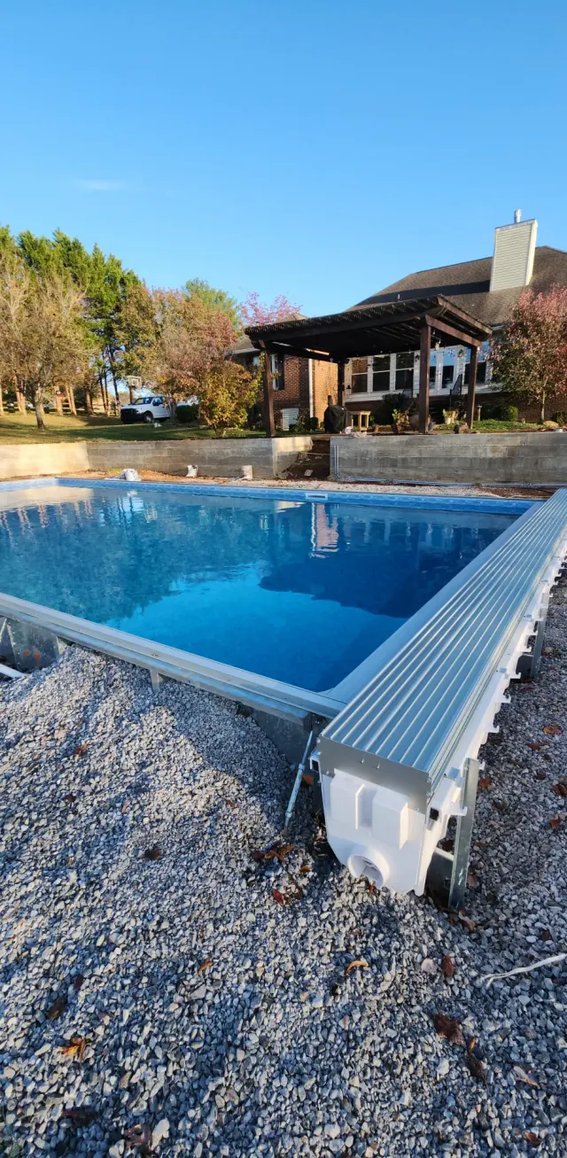 Newly constructed inground pool at sunset